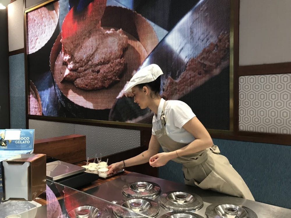 a person serving Italian gelato on a table