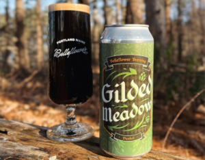 Gild Meadow can of beer can with goblet of beer in the woods