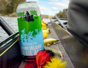 Rising Tide MITA IPA Can with Fishing Lures on the side of a boat.