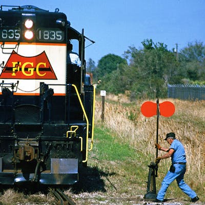 a man standing next to a train