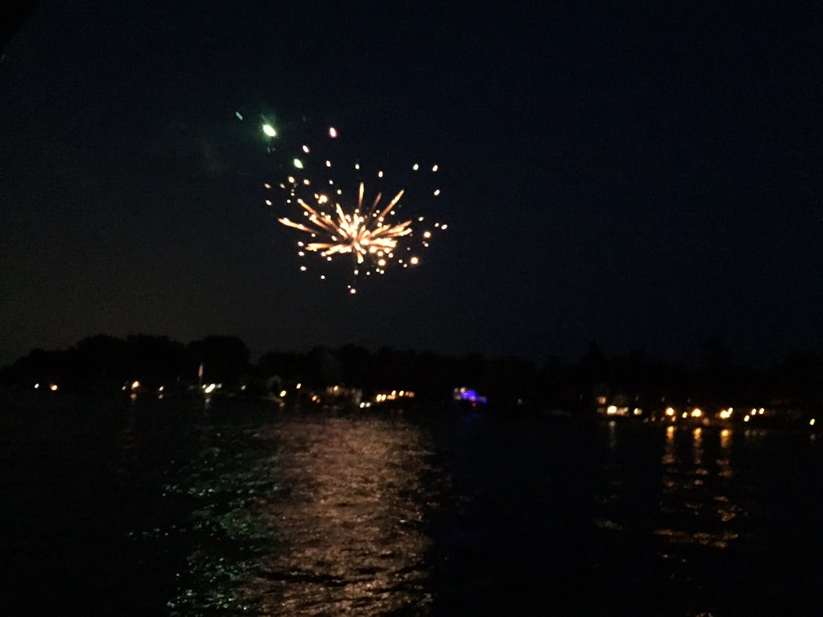 fireworks in the night sky over a body of water