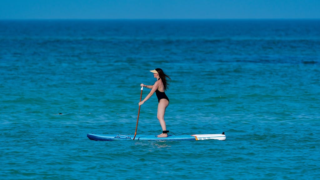 a person riding a surf board on a body of water