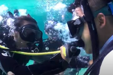 divers exhanging air during PADI rescue Course