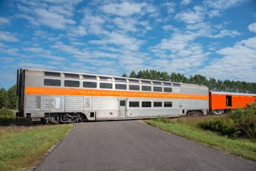 a train is parked on the side of a road