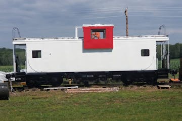 a train that is sitting in the grass
