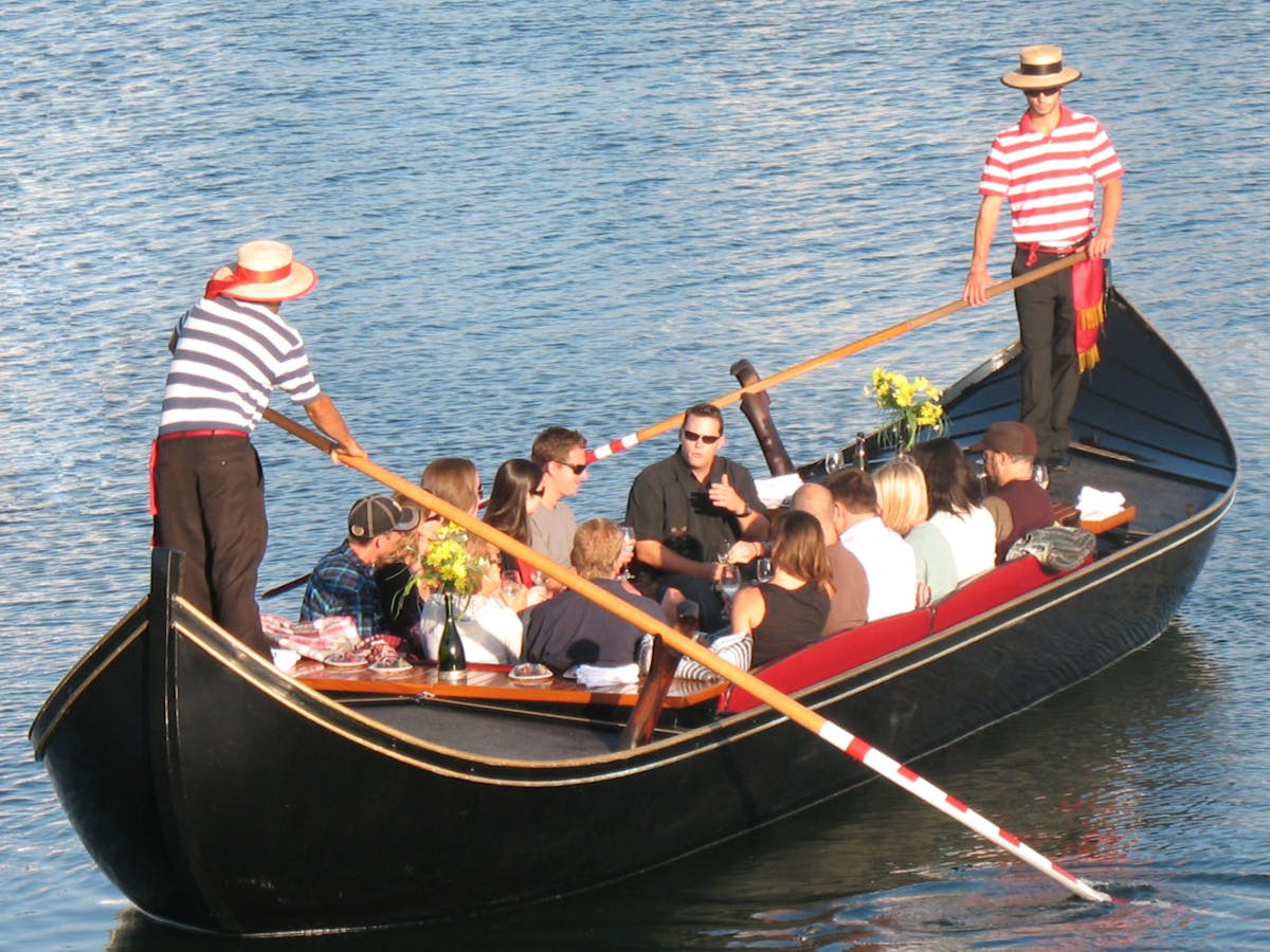 a group of people in a small boat in a body of water