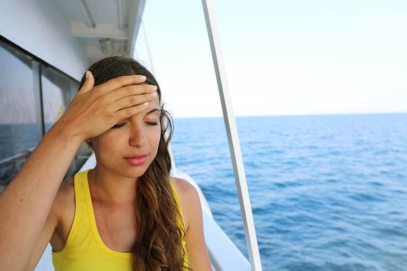 A woman feeling seasick on a boat