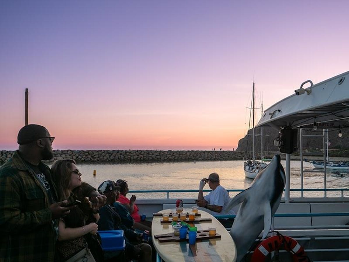 Guests enjoy beer and the sunset during Brews Cruise beer tasting experience in Dana Point