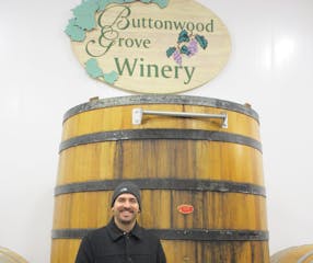a man standing in front of a barrel