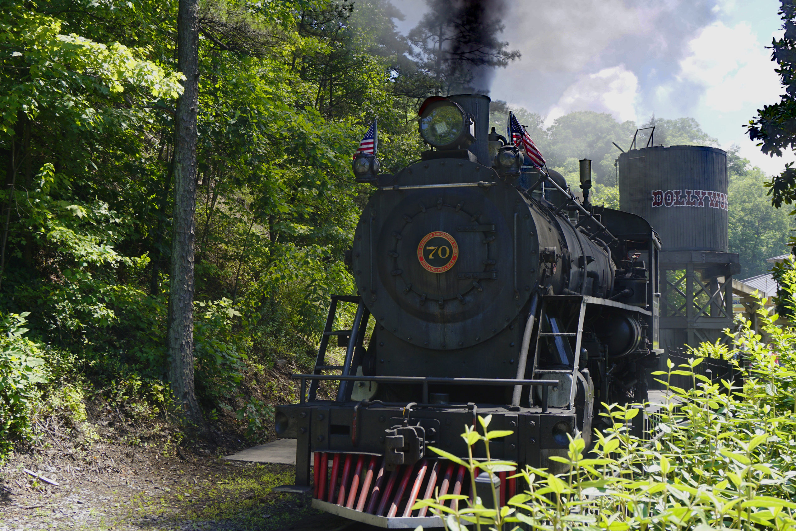 Steam engine pulling the train out of the station at Dollywood amusement park