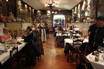 a group of people sitting at a table in a restaurant