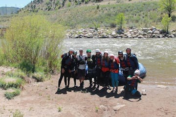 a group of people standing next to a body of water