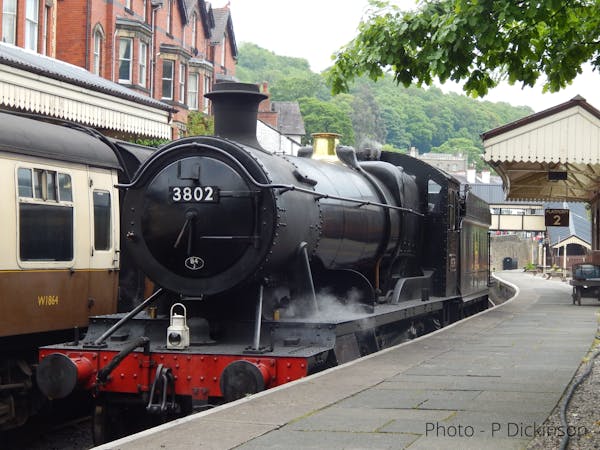 a steam engine is sitting in the station