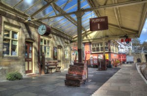 Llangollen Station with trunks and cases on the platform