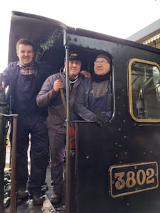 Volunteer train crew onboard a steam engine