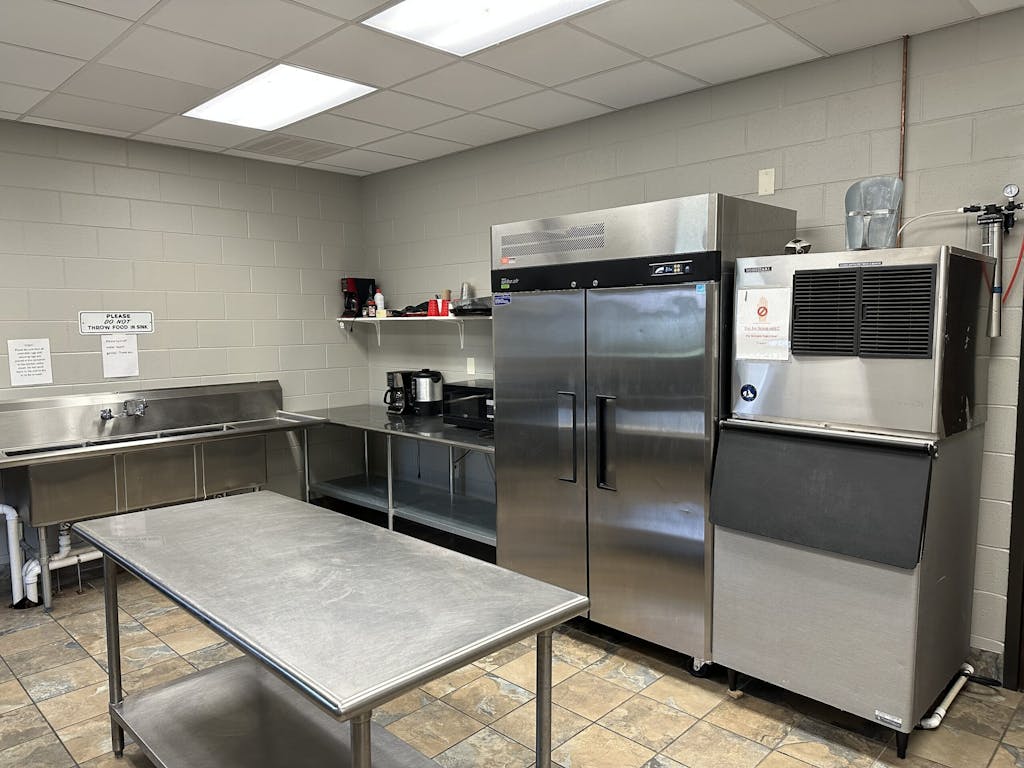 a large commercial kitchen with stainless steel appliances