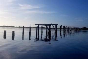 a close up of a pier next to a body of water