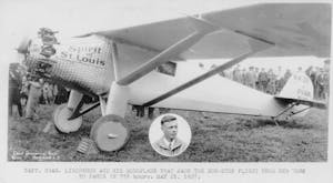 Charles Lindberg the Spirit of St Luoisa small airplane sitting on top of a grass covered field