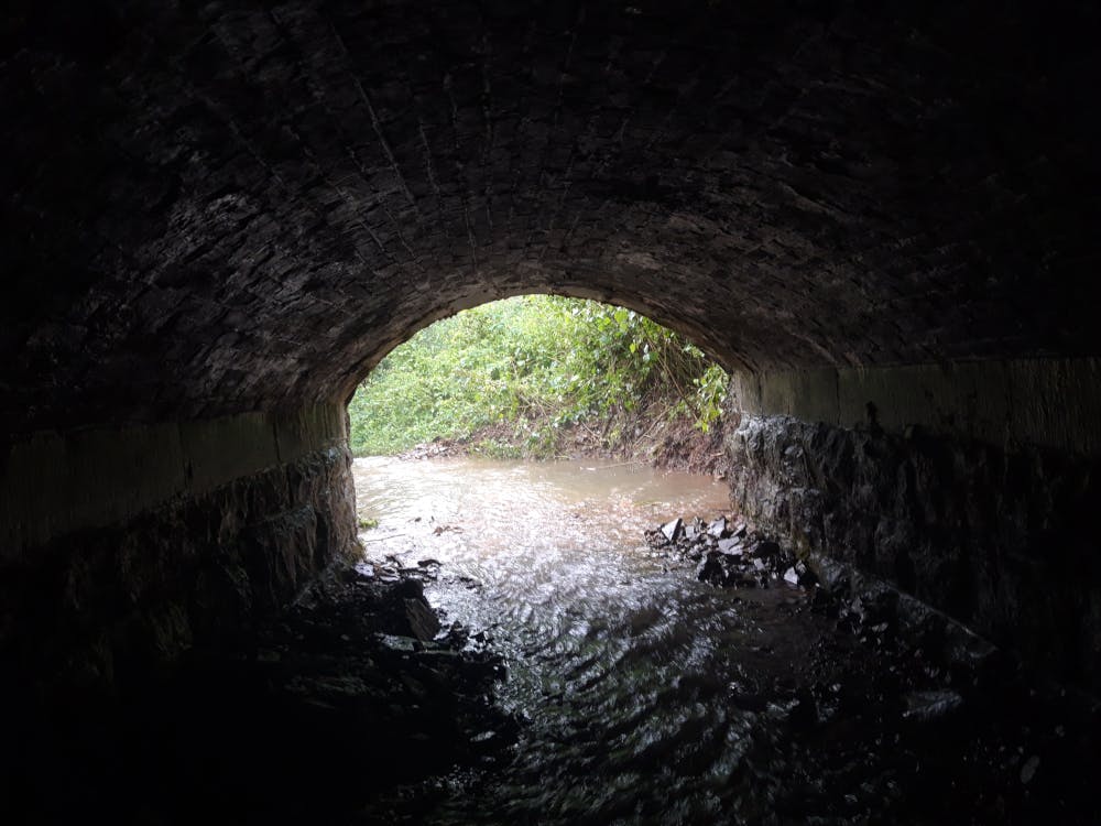 a tunnel with water in the dark