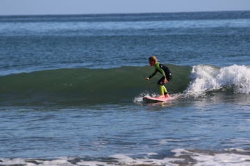 a man riding a wave on a surfboard in the water