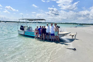 a group of people standing by a boat in the water