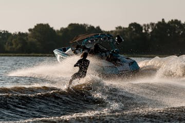 man wakeboarding behind a boat