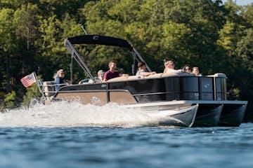 a group of people riding on the back of a pontoon
