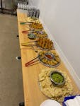 a wooden table topped with plates of food