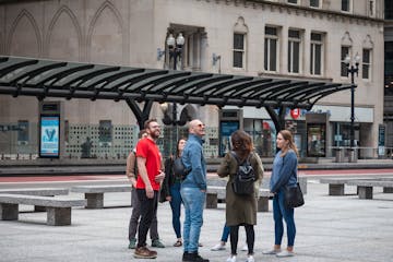a group of people walking in front of a building