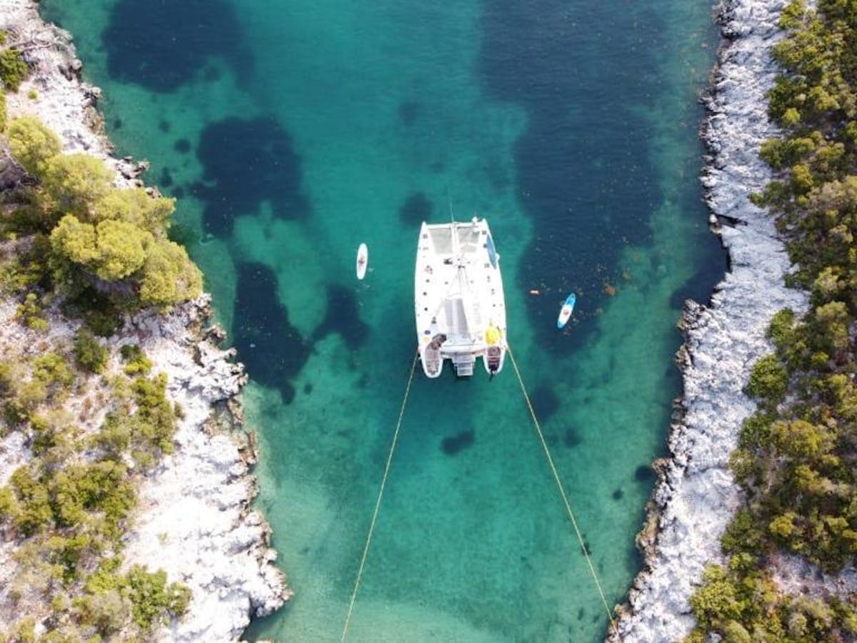 Our catamaran anchored in a bay in Poliegos
