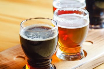 a close up of a glass of beer on a wooden table