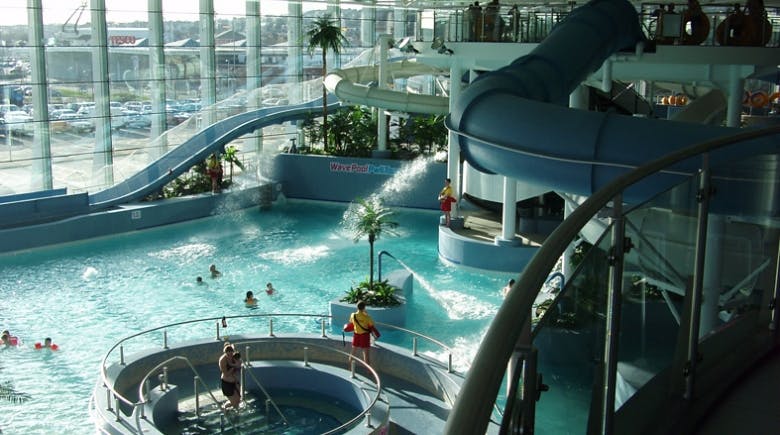 A photo of an indoor swimming pool and slides