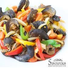 a plate of Spicy African Giant Snail with vegetables 