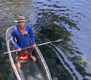 a person riding on the back of a boat in the water
