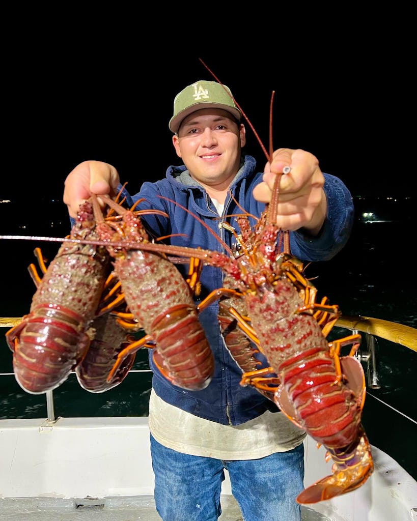a person holding a lobster
