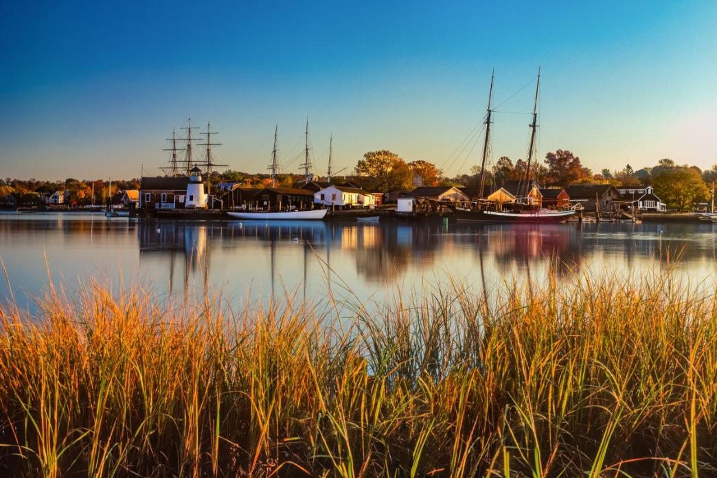 mystic connecticut harbor with ships during golden hour