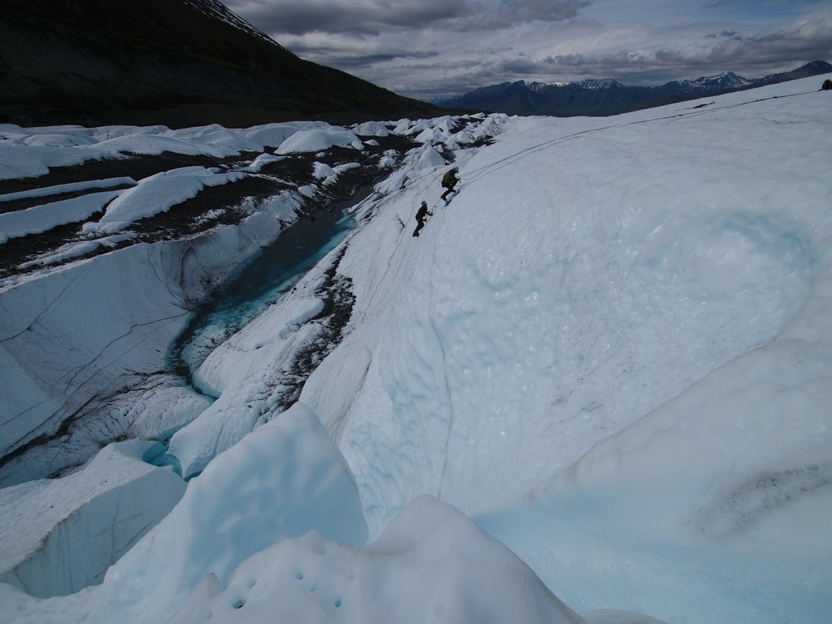 two people above glacier water ice climbing
