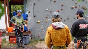 MICA Guides practicing their training skills by a rock wall