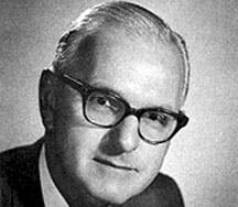 William F. Harrah wearing glasses and looking at the camera
