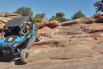 a person riding a motorcycle down a dirt road