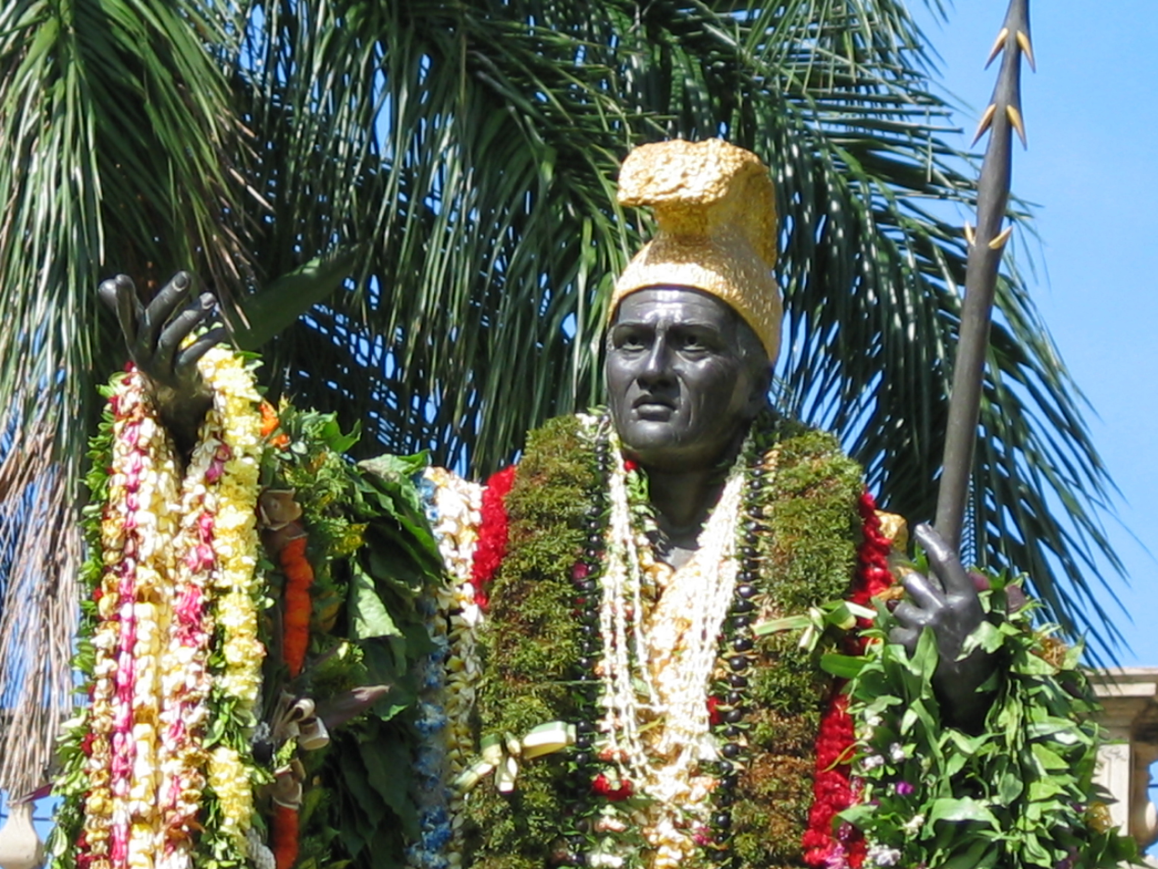 a-statue-in-front-of-a-palm-tree-king-kamehameha