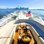 NY boat charters with brunch or lunch and the skyline in the distance and the American flag waving