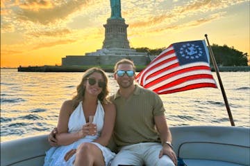 man and a woman during a sunset cruise NY after a surprise marriage proposal on a boat