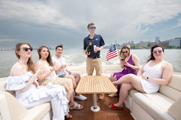 friends on boat rides around nyc with champagne