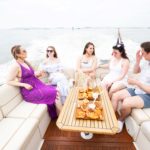friends boating in nyc drinking champagne while in the new york harbor