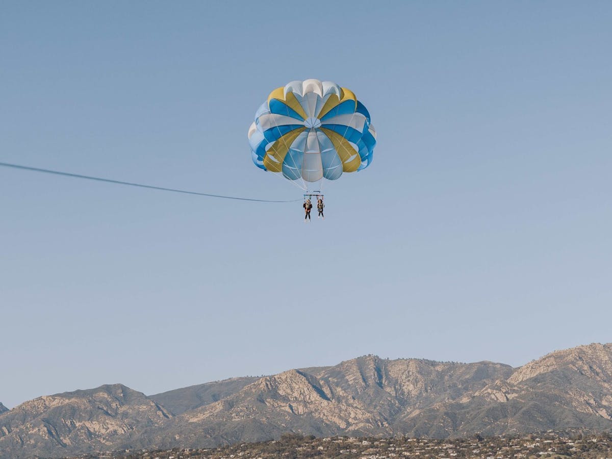 a parachute is flying over a body of water
