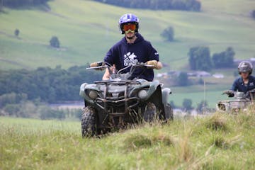 a man riding a motorcycle in a field