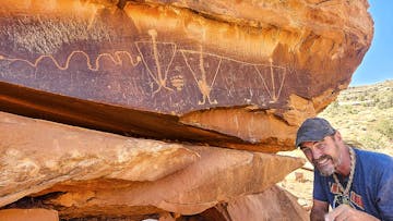Guide Sean-Paul showing off petroglyph on the Hurrah Pass Tour