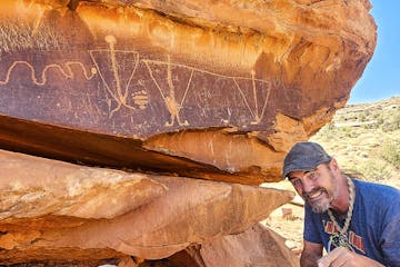 Guide Sean-Paul showing off petroglyph on the Hurrah Pass Tour