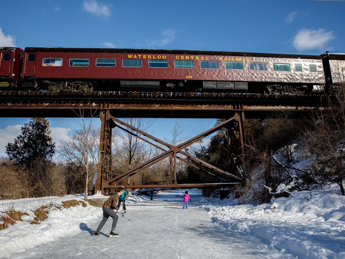 a train riding through a snow covered bridge